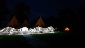 Tipis and Bell Tents at night