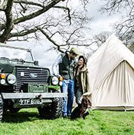 Couple in from of a Bell tent